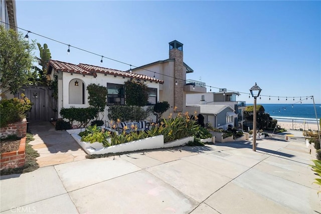 view of front of home with a water view