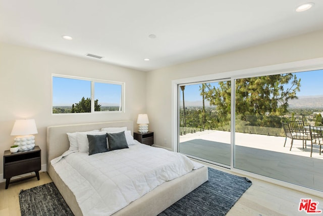 bedroom with access to outside and light hardwood / wood-style flooring