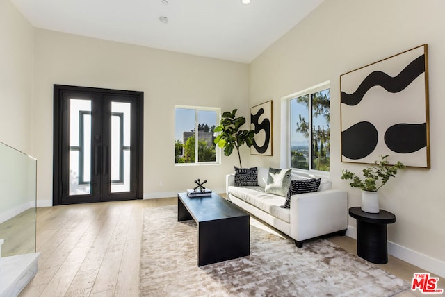 living room with light wood-type flooring and french doors