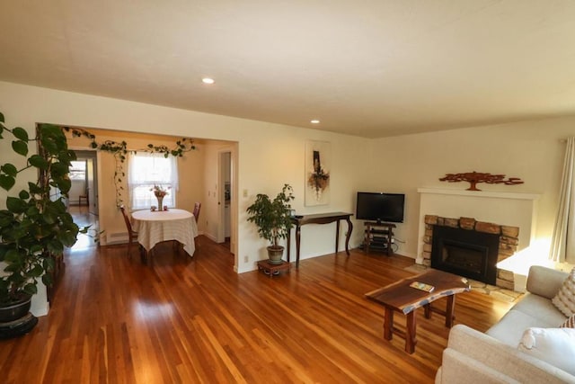 living room with hardwood / wood-style flooring and a fireplace