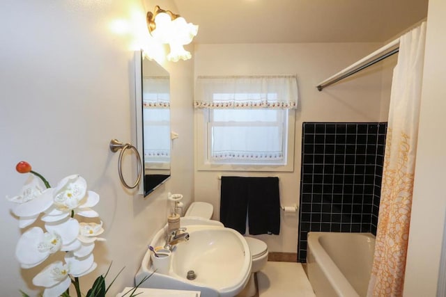 full bathroom featuring sink, shower / tub combo, and toilet