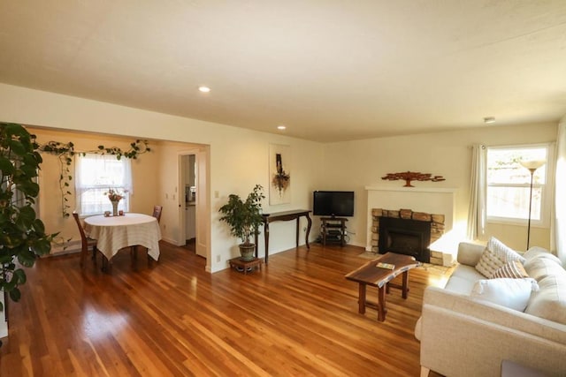 living room with hardwood / wood-style flooring and a fireplace