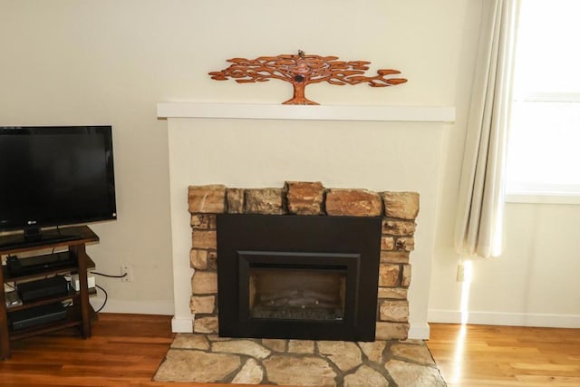 interior details with hardwood / wood-style flooring and a fireplace