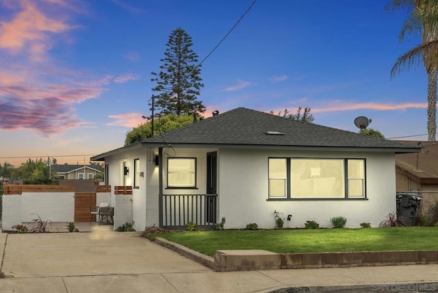 bungalow featuring a yard