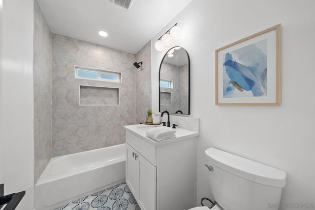 full bathroom with tiled shower / bath combo, vanity, and toilet