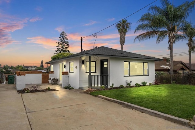 view of front of property with a lawn and a patio