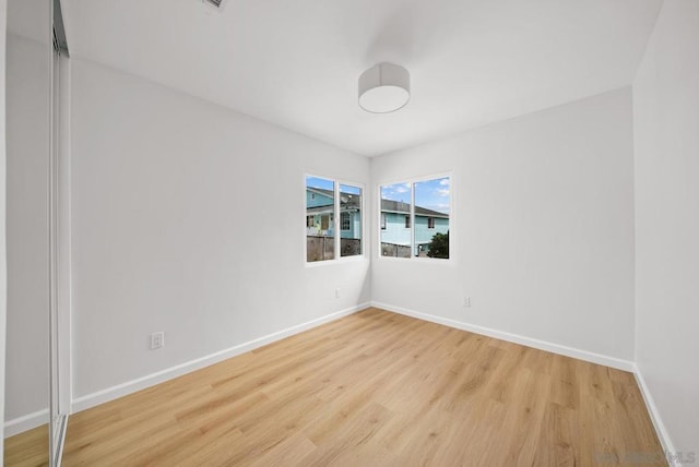 empty room with light hardwood / wood-style floors