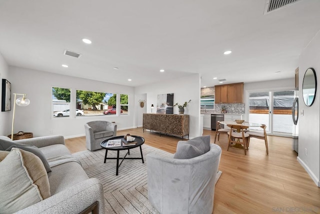 living room featuring sink and light wood-type flooring