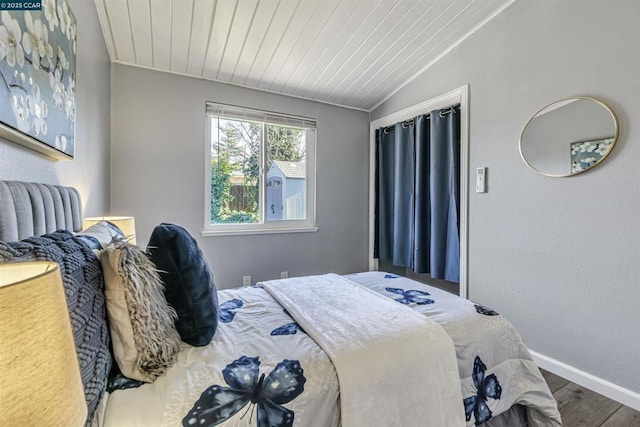 bedroom featuring lofted ceiling, wood ceiling, and wood-type flooring