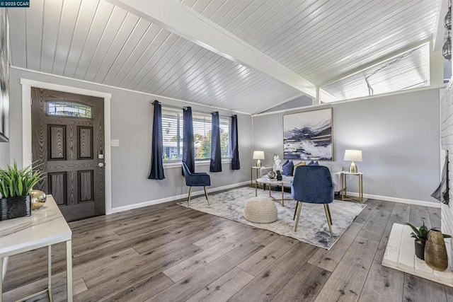 interior space with hardwood / wood-style flooring and vaulted ceiling with beams