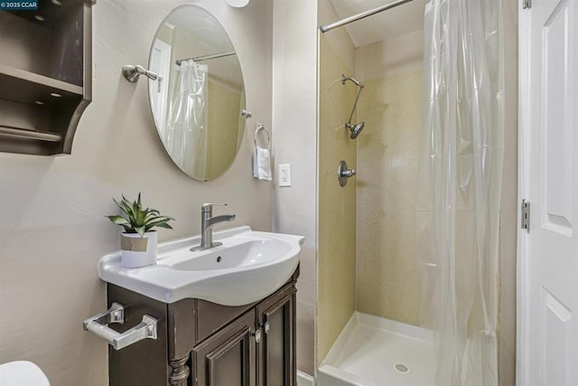 bathroom featuring vanity and curtained shower