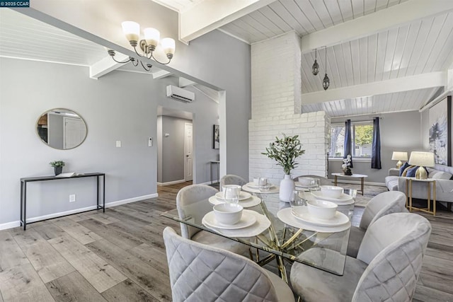 dining room with a notable chandelier, beam ceiling, a wall unit AC, and light hardwood / wood-style floors