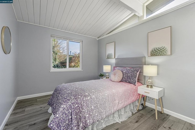 bedroom with wood-type flooring and lofted ceiling with beams