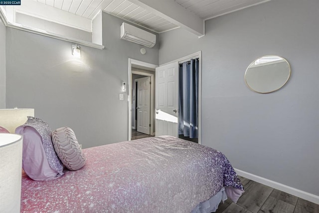 bedroom featuring dark hardwood / wood-style floors, an AC wall unit, and beamed ceiling