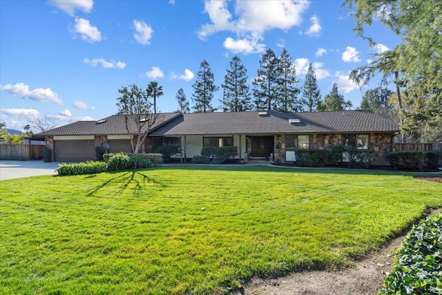 single story home with a garage and a front yard