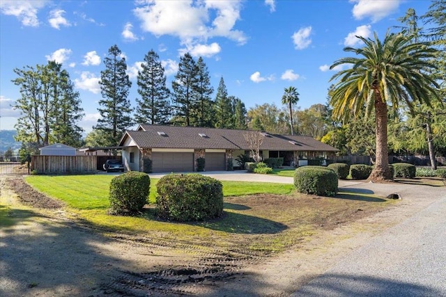 single story home with a garage and a front yard