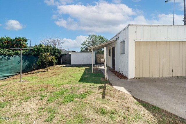 view of yard featuring an outdoor structure and a fenced backyard