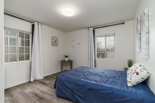 bedroom with wood finished floors and baseboards