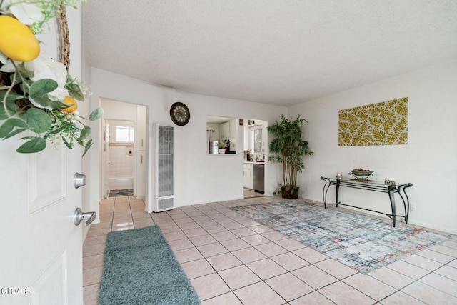 entrance foyer featuring a textured ceiling and light tile patterned floors