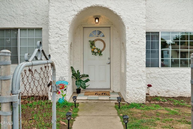 view of exterior entry with stucco siding