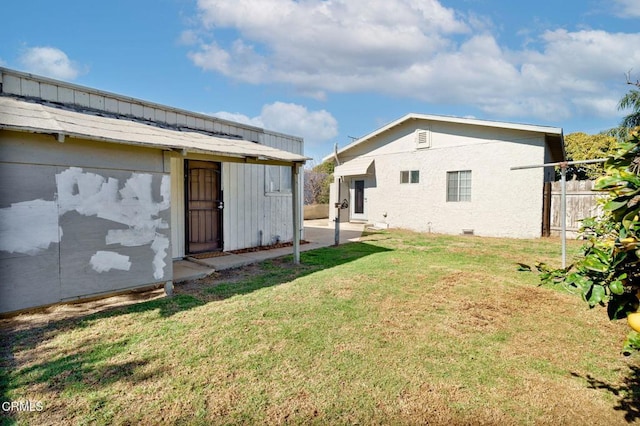 view of yard with an outdoor structure and fence