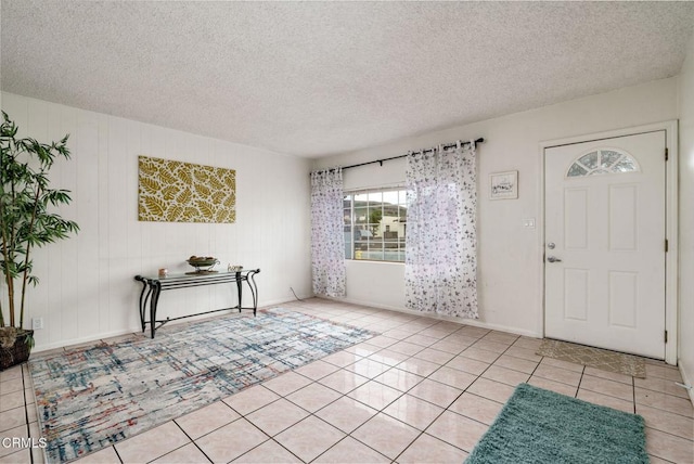 tiled foyer entrance featuring a textured ceiling