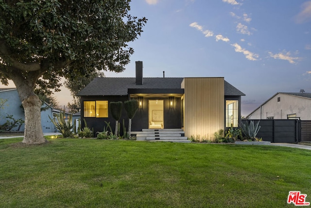 view of front of home with a yard