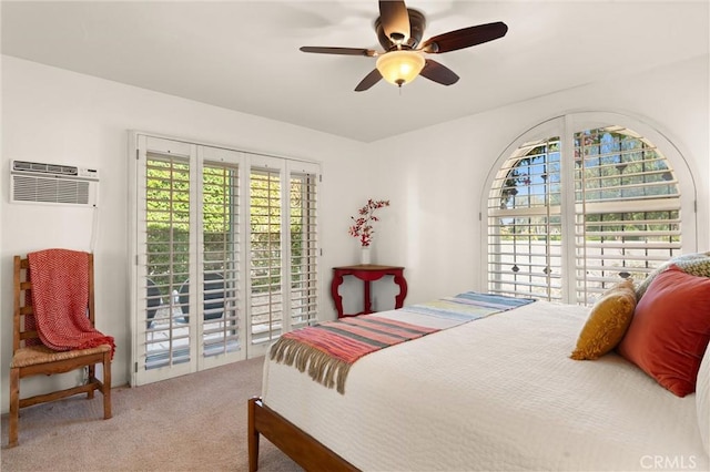 bedroom featuring access to exterior, an AC wall unit, ceiling fan, and carpet