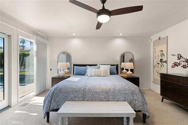 bedroom featuring light carpet, access to exterior, and ceiling fan