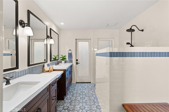 bathroom featuring a shower and vanity