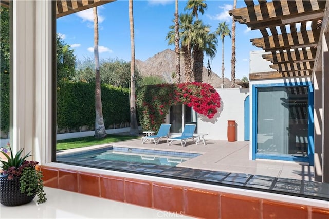 view of swimming pool featuring a mountain view and a patio