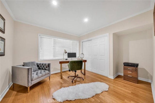 home office with crown molding and light wood-type flooring