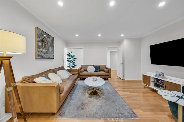 living room featuring crown molding and light hardwood / wood-style floors