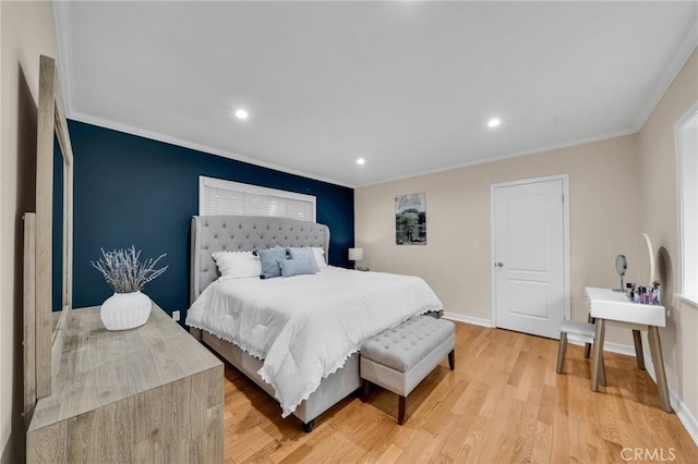 bedroom with ornamental molding and light hardwood / wood-style floors