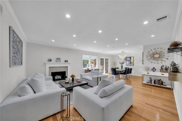 living room with crown molding and wood-type flooring