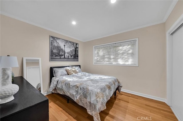 bedroom featuring hardwood / wood-style flooring and ornamental molding