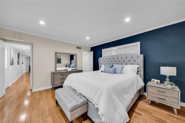 bedroom with light hardwood / wood-style flooring and ornamental molding