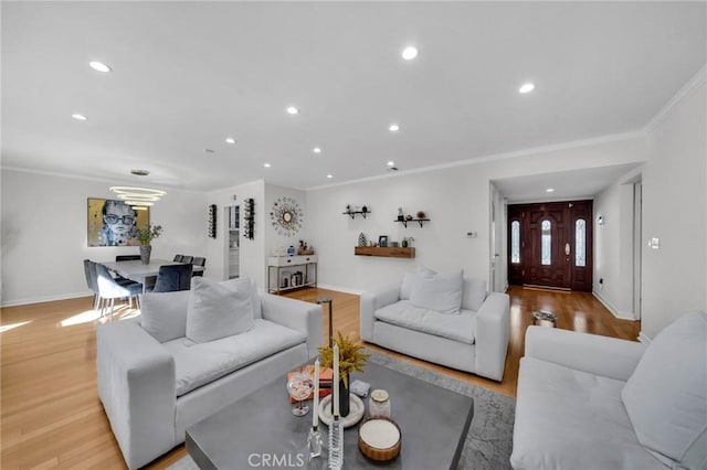 living room featuring ornamental molding and light hardwood / wood-style floors