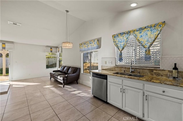 kitchen with decorative light fixtures, stainless steel dishwasher, open floor plan, white cabinetry, and a sink