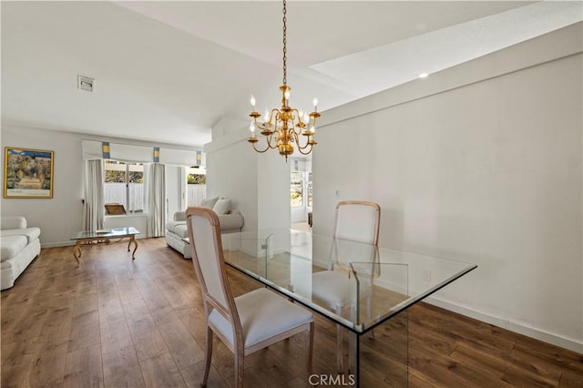 dining space featuring a chandelier, dark wood finished floors, visible vents, and baseboards