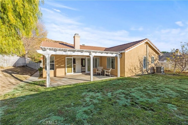 back of house with central air condition unit, fence, a yard, a pergola, and a patio area