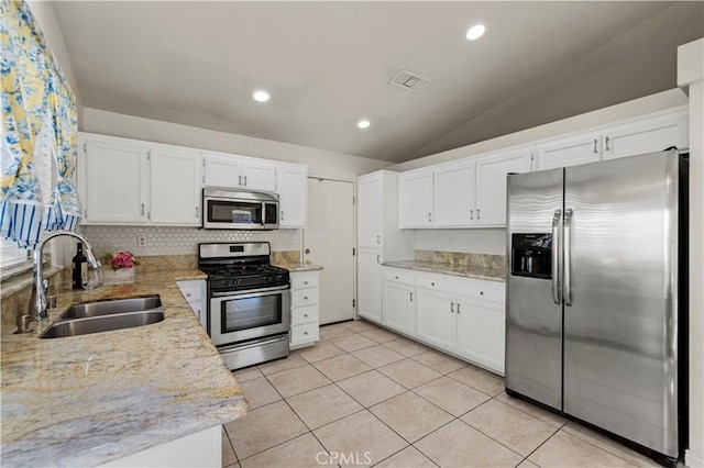 30431 Sunrose Pl, Canyon Country, CA 91387 - kitchen with appliances with stainless steel finishes, tasteful backsplash, white cabinetry, light tile patterned floors, and lofted ceiling