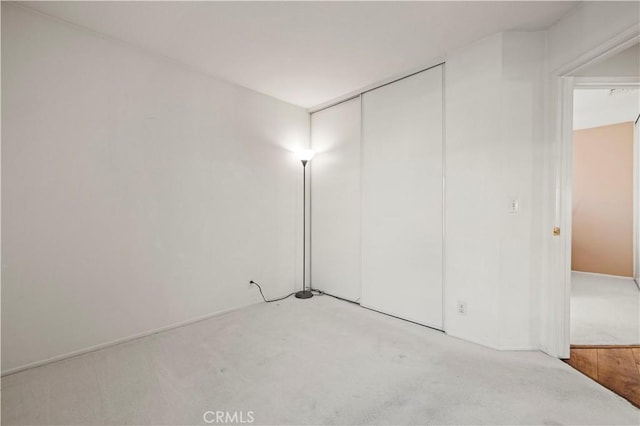 unfurnished room with light carpet