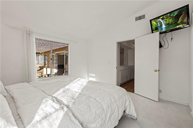 carpeted bedroom with visible vents and vaulted ceiling