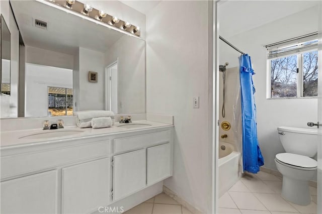 full bath featuring shower / bath combination with curtain, visible vents, a sink, and tile patterned floors