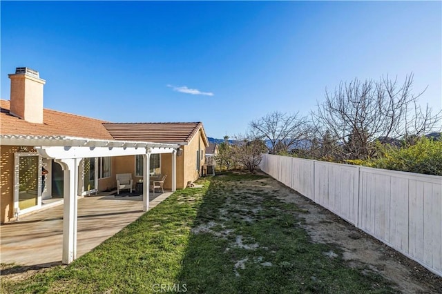 view of yard featuring a patio, a fenced backyard, and a pergola