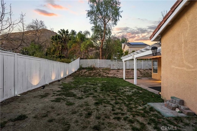 30431 Sunrose Pl, Canyon Country, CA 91387 - yard at dusk featuring a fenced backyard, a patio, and a pergola