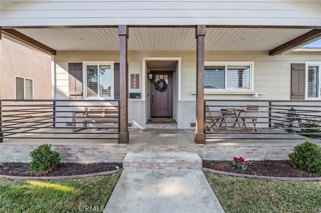 view of exterior entry with a porch