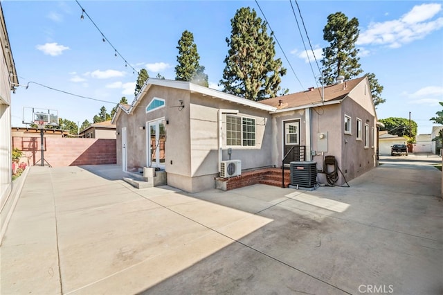 view of front of home with ac unit, cooling unit, and a patio area