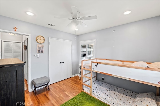 bedroom featuring hardwood / wood-style floors, a closet, and ceiling fan